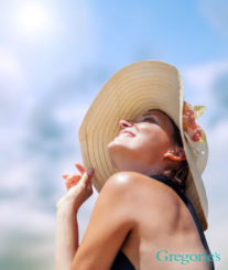 woman with sun hat on sitting in the sunshine.