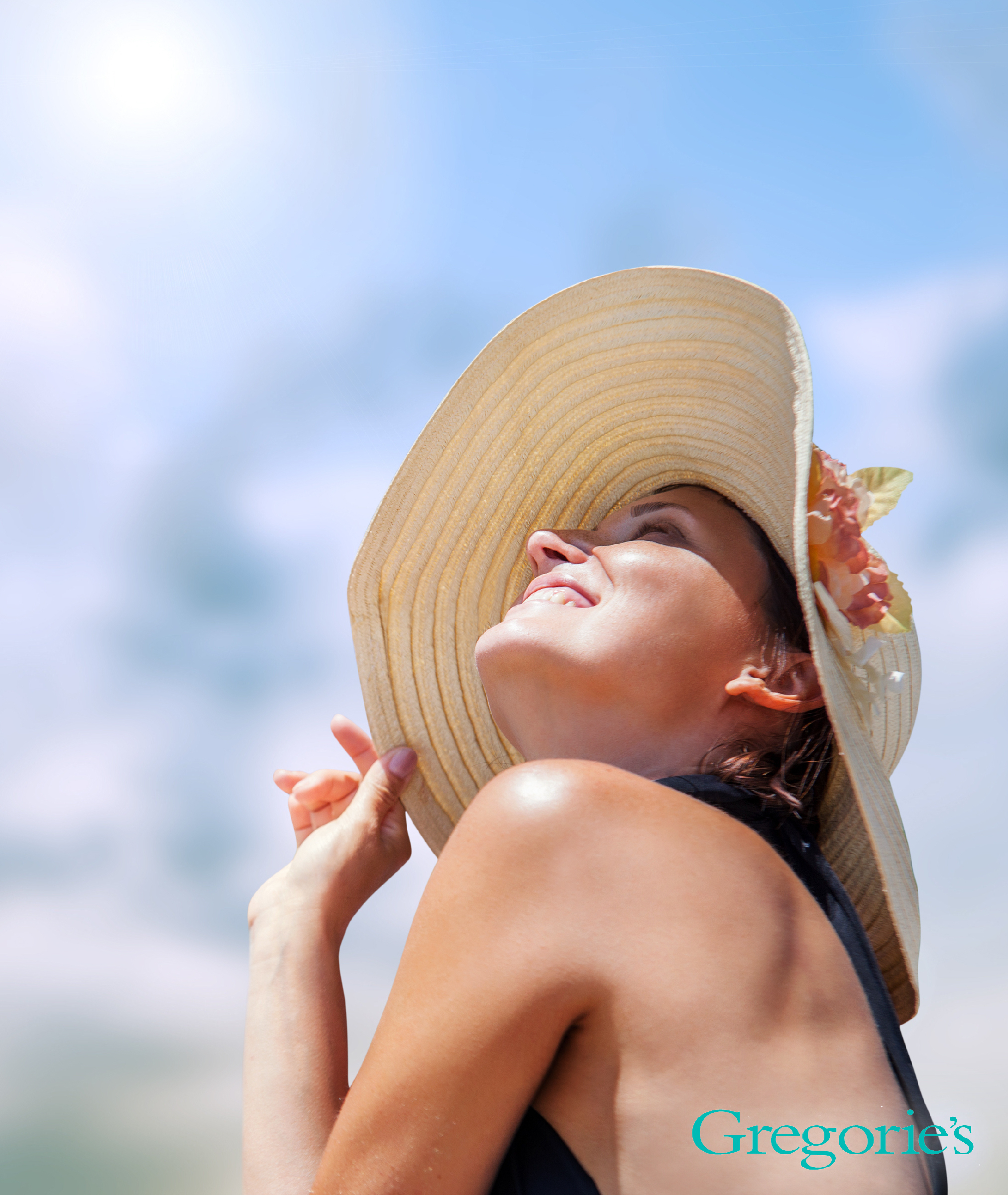 woman with sun hat on sitting in the sunshine.